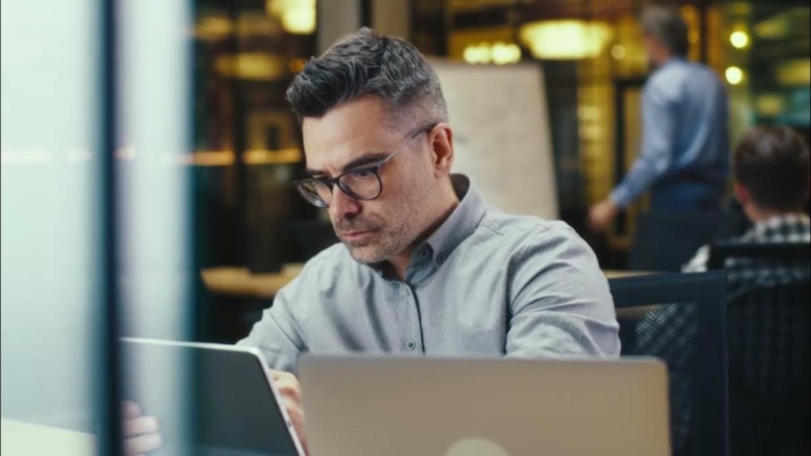 Professional workspace showing organized financial planning materials and laptop